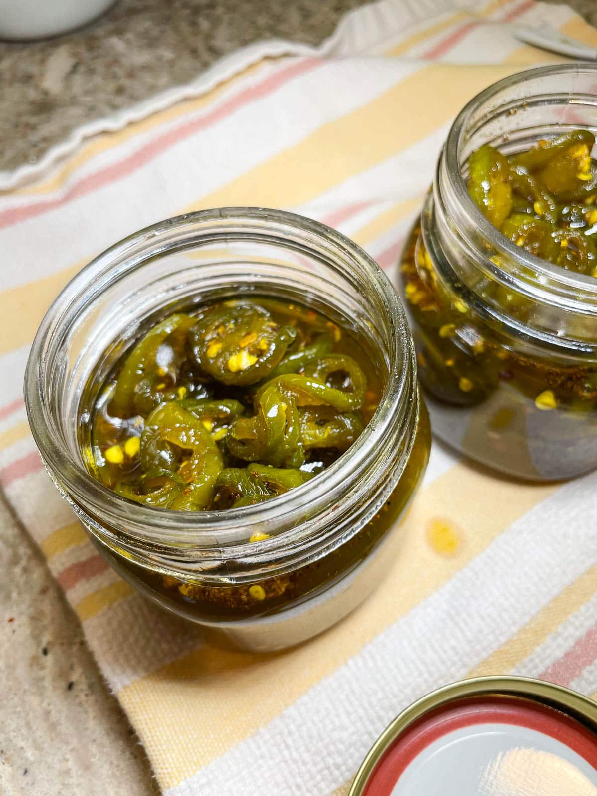 candied jalapeños in glass jars