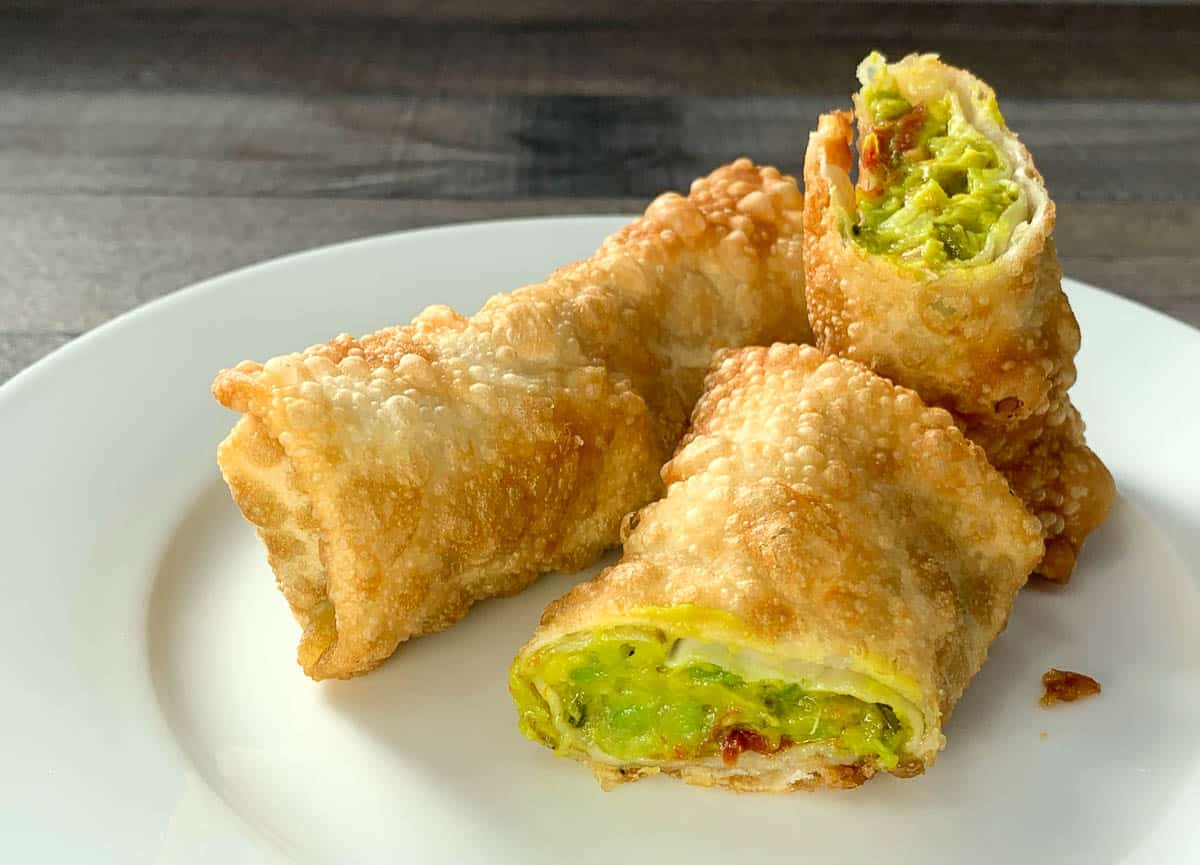 delicious jalapeño avocado egg rolls on a white plate