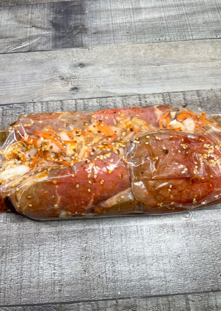 sliced round steak marinating