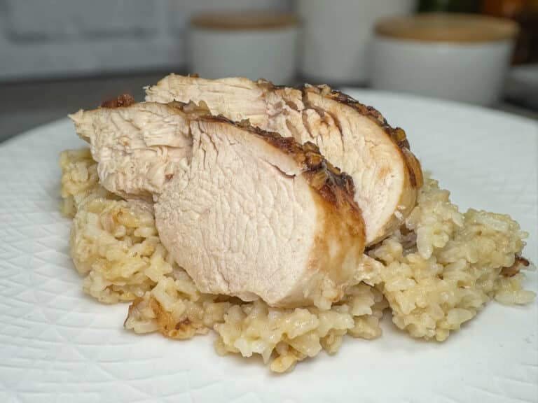 slices of chicken on bed of rice