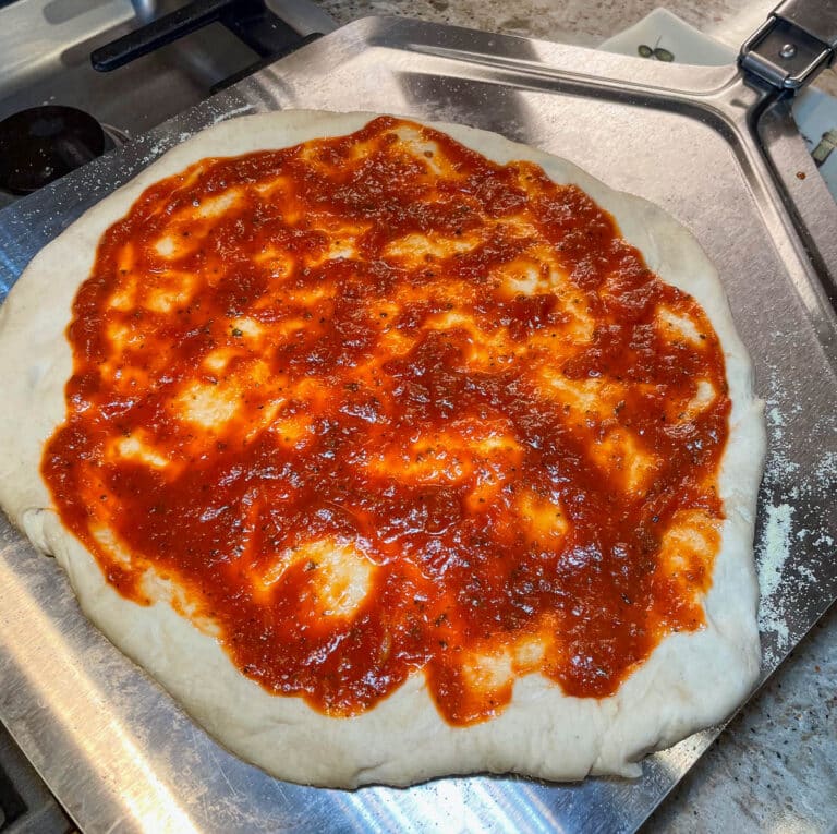 pizza sauce on pizza dough